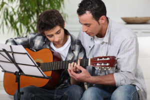 http://www.dreamstime.com/stock-photos-father-teaching-son-guitar-image26792023