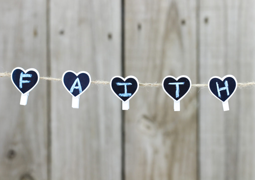 FAITH hearts hanging on clothesline with wooden background