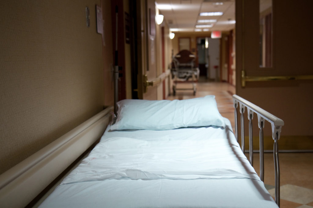 A bed with railing at a hospital corridor
** Note: Shallow depth of field